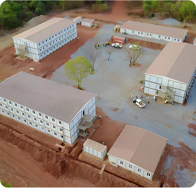 Aerial View of Remote Workforce Accommodation Camp in Africa Aerial view of modular workforce accommodation camp with multiple buildings on a remote site in Africa.