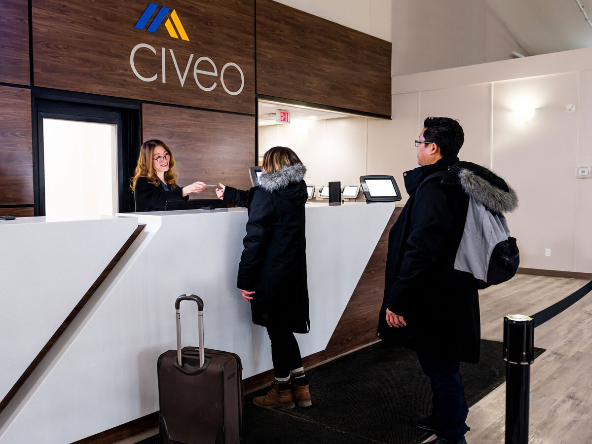 civeo-wapasu-front-desk-agent-provides-room-card