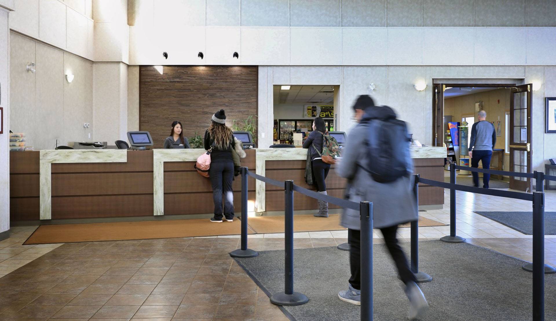 man-walks-toward-reception-checking-in