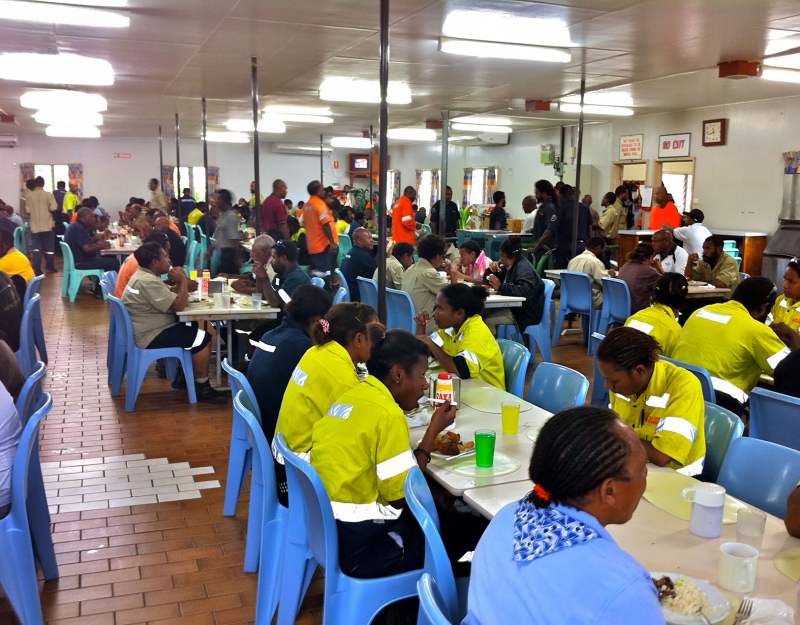 Fly-in fly-out workers in west Africa eat lunch at a messing hall in a modular structure