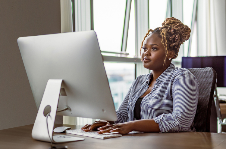 travel-coordinator-sits-desk-typing